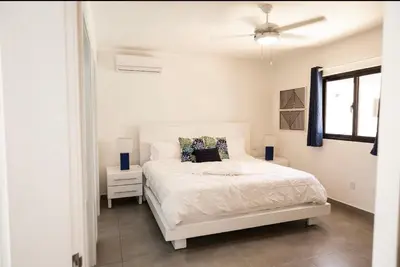 a white bedroom with a bed and a ceiling fan at Bonita Extravaganza 4 Bedroom, 4 Bed, 3 Bedroom in Sosúa