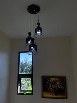 two lights hanging from a ceiling next to a window at Villa Anaylia
