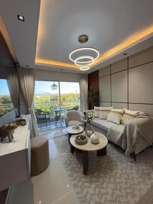 a living room with a couch and a table at spectrum stay in Baní