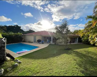 a house with a swimming pool in a yard at Two residences for one stay in Sosua in Sosúa