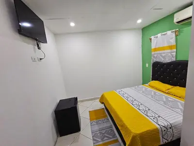 a bedroom with a bed and a tv in it at W&W Hotel in Las Terrenas
