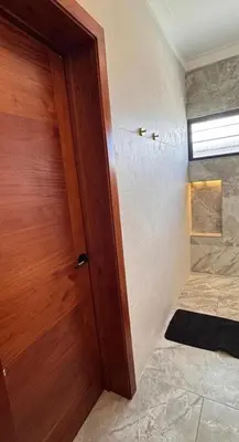 a wooden door in a room with a shower at Luxury Caribbean Oasis in La Romana