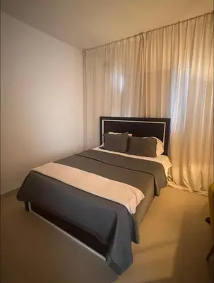 a bedroom with a large bed in front of a window at Luxury Caribbean Oasis in La Romana
