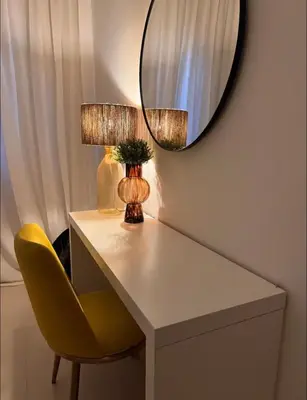 a table with a yellow chair and a mirror at Luxury Caribbean Oasis in La Romana