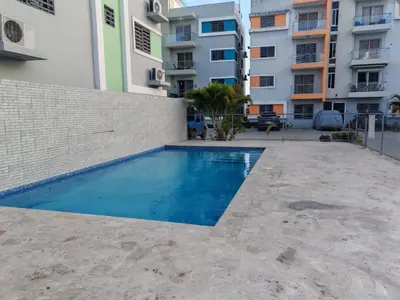 a swimming pool in front of a building at Condominio Esperanza B102 in San Pedro de Macorís