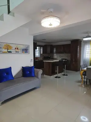 a living room with a couch and a kitchen at Naime 3 Bristol villa in San Pedro de Macorís