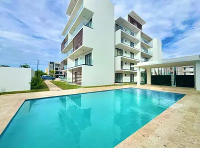 a swimming pool in front of a building at Modern 1B 5 min to CapCana Beach in Las Terrenas