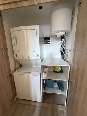 a small kitchen with a white refrigerator and a sink at Modern 1B 5 min to CapCana Beach in Las Terrenas