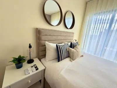 a bedroom with a bed with a mirror on the wall at Modern 1B 5 min to CapCana Beach in Las Terrenas