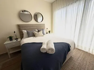 a bedroom with a large bed with towels on it at Modern 1B 5 min to CapCana Beach in Las Terrenas