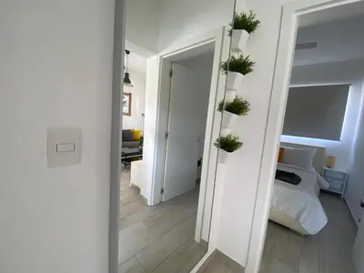 a bedroom with a bed and plants on the wall at Your Beautiful Village Central 5 Min from the Beach in Punta Cana