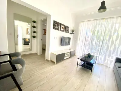 a living room with a couch and a table at Your Beautiful Village Central 5 Min from the Beach in Punta Cana