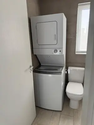 a small bathroom with a toilet and a tv on top at Your Beautiful Village Central 5 Min from the Beach in Punta Cana