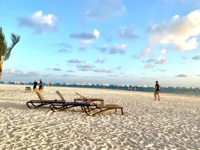 a beach with two lounge chairs and the ocean at Your Beautiful Village Central 5 Min from the Beach in Punta Cana