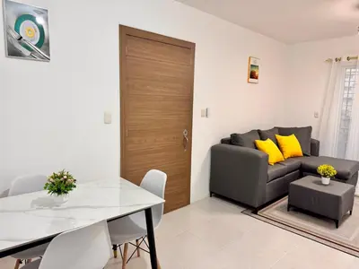 a living room with a table and a couch at Ocean View Fast Wifi Close to Everything Coffee 2BR in La Cana
