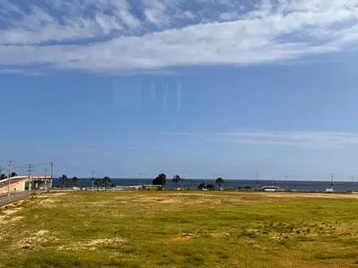 a view of a field with the ocean in the background at Ocean View Fast Wifi Close to Everything Coffee 2BR in La Cana