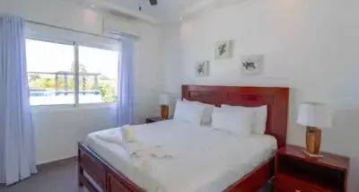 a bedroom with a large bed and a window at Ocean reset in Sosúa