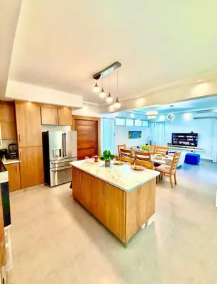 a large kitchen and living room with a table and chairs at Ocean reset in Sosúa