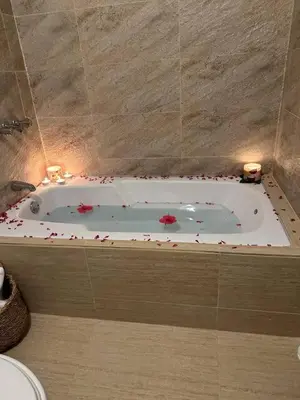 a bathroom with a bath tub with flowers in it at Los Patos Beach Rooms in Colorado