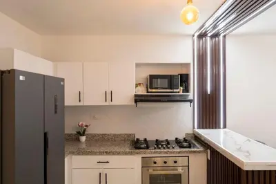 a kitchen with a stove and a microwave at Beautiful apartment on the 2nd floor in Boca Residence