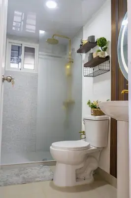 a bathroom with a toilet and a shower and a sink at Beautiful apartment on the 2nd floor in Boca Residence