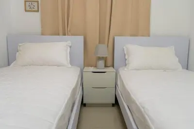 two beds sitting next to each other in a bedroom at Beautiful apartment on the 2nd floor in Boca Residence