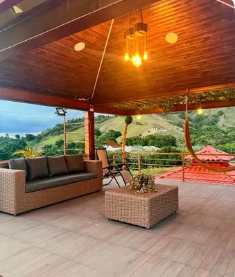 a patio with a couch and chairs on a deck at Villa lobos in Concepción de La Vega