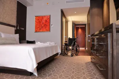 a room with a bed and a wheelchair in it at InterContinental Real Santo Domingo by IHG in Santo Domingo