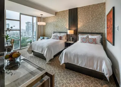 a hotel room with two beds and a window at InterContinental Real Santo Domingo by IHG in Santo Domingo