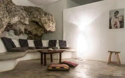 a living room with a couch and a table at La Cueva Eco-Lodge in Las Galeras