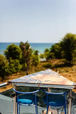 two chairs sitting under a table with an umbrella at Sunset Samana in Las Galeras