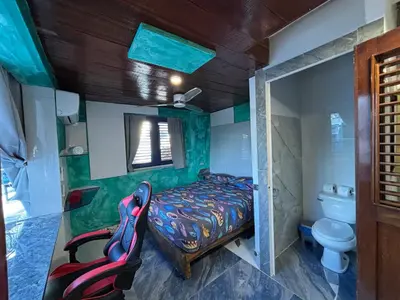 a small bedroom with a bed and a toilet at Sunset Samana in Las Galeras