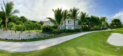 a house on a road with palm trees at Luxury Private Villas with Pool, Private Beach, BBQ in Punta Cana