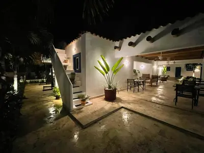 a patio at night with a surfboard in the middle at Nuovo Hotel Playa Catalina in La Romana