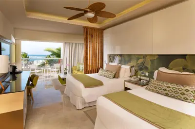 a hotel room with two beds and a balcony at Dreams Onyx Resort & Spa - All Inclusive in Punta Cana