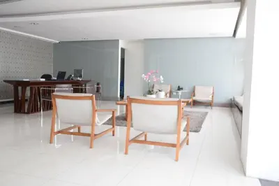 a living room with chairs and a table and a desk at Lincoln Suite in Santo Domingo