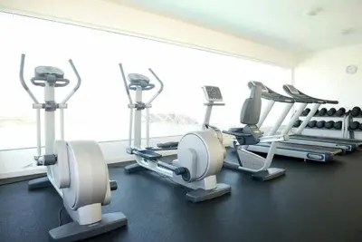 a gym with several tread machines in a room at Lincoln Suite in Santo Domingo