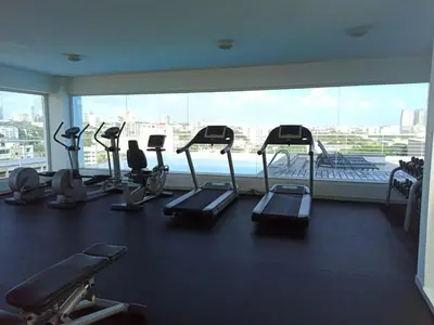 a gym with several treadmills and a large window at Lincoln Suite in Santo Domingo