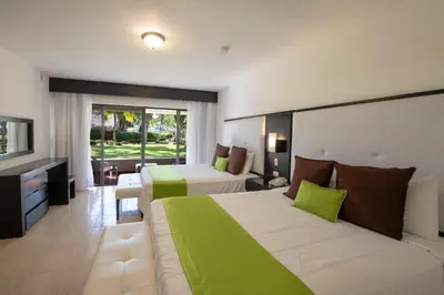 a hotel room with two beds and a television at Viva Dominicus Beach by Wyndham, A Trademark All Inclusive in Bayahibe