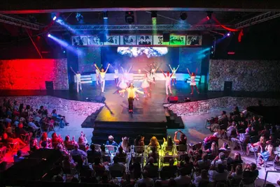 a stage with a group of people performing on it at Viva Dominicus Palace by Wyndham, A Trademark All Inclusive in Bayahibe