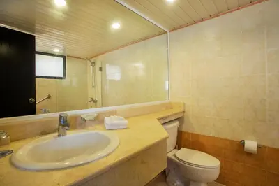 a bathroom with a sink and a toilet and a mirror at Viva Dominicus Palace by Wyndham, A Trademark All Inclusive in Bayahibe