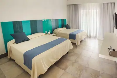 two beds in a room with green and white at Viva Tangerine by Wyndham, A Trademark All Inclusive in Cabarete