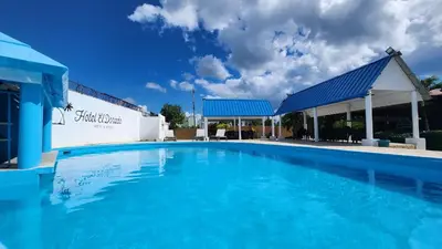 a large blue swimming pool in front of a building at Hotel El Dorado in La Romana