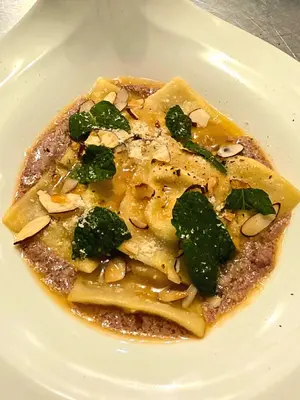 a plate of food with pasta with broccoli and nuts at Hotel El Dorado in La Romana
