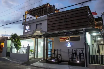 a building with a bar in front of it at Hotel Casa Jum in Santiago de los Caballeros