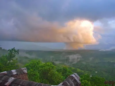 a view of a rain storm with a rainbow in the sky at Ecolodge Tubagua Puerto Plata in Tubagua