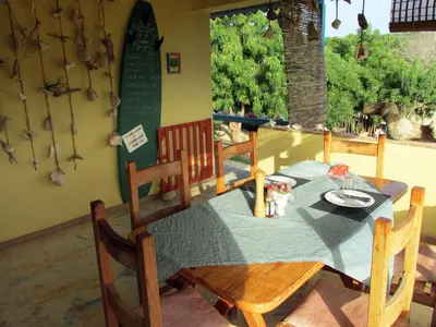a dining room table and chairs with a green table cloth at Corales Punta Rusia in Punta Rucia