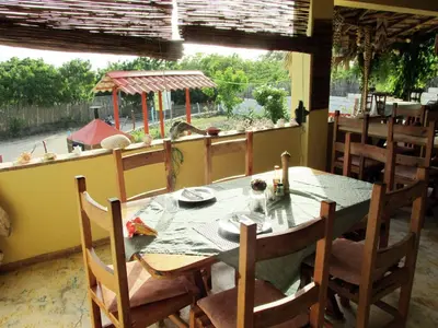 a dining room with a table and chairs and a window at Corales Punta Rusia in Punta Rucia