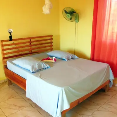 a bedroom with a bed with a stuffed animal on it at Corales Punta Rusia in Punta Rucia