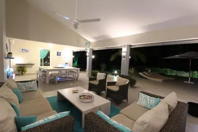 a living room with a couch and chairs and a table at Villa Talanquera in Las Galeras